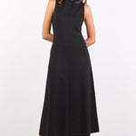 Woman wearing a black sleeveless dress on a white background