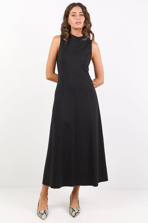Woman wearing a black sleeveless dress on a white background