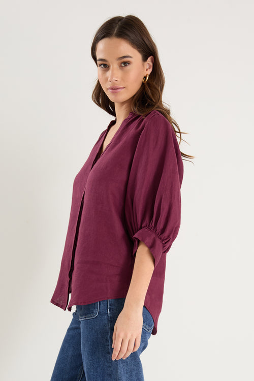 burgundy blouse on model 