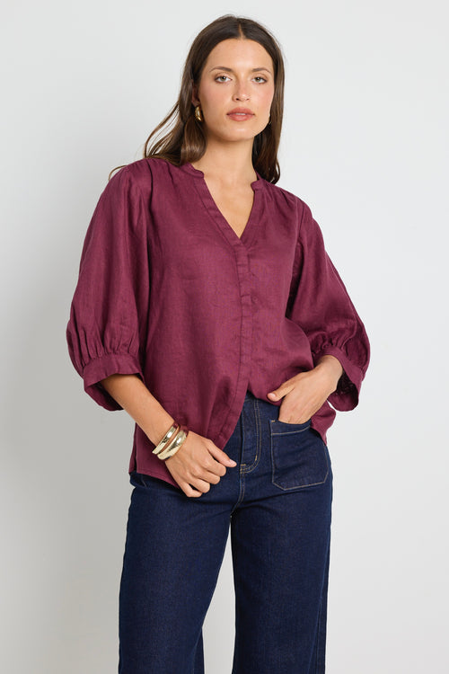 model wears burgundy blouse