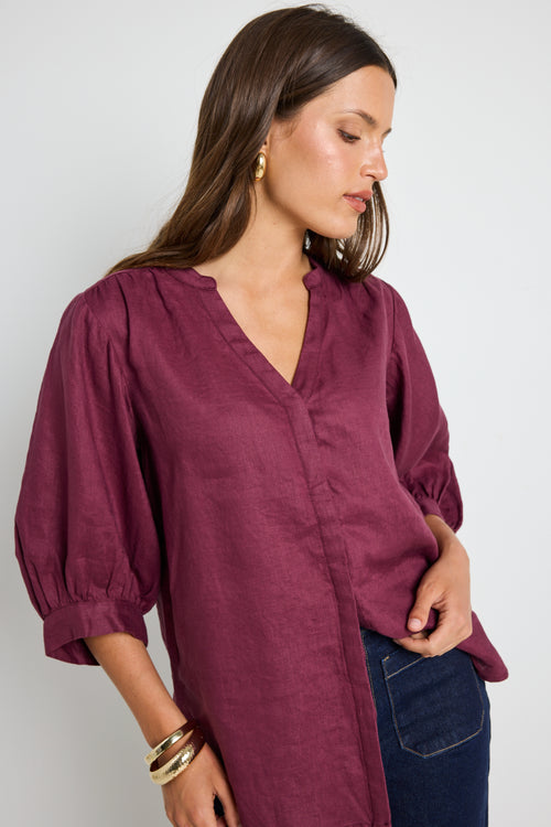 model wears burgundy blouse