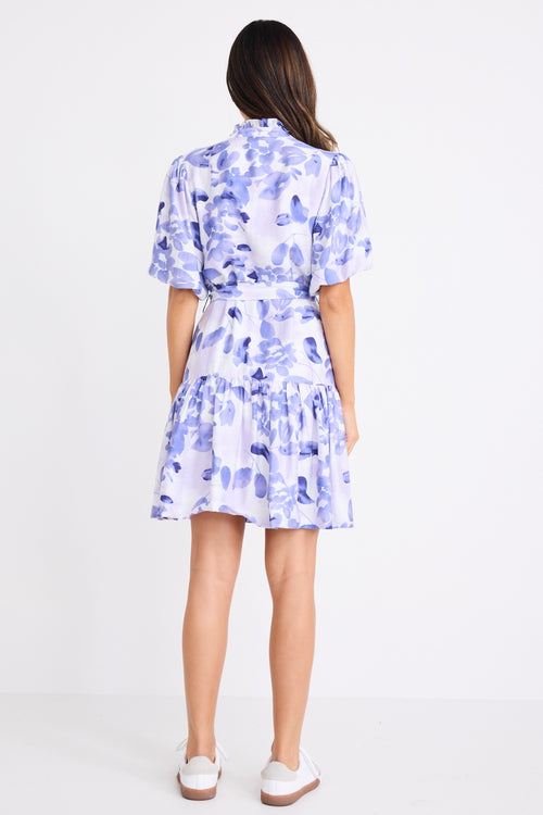 model wears a blue and white floral mini dress