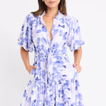 model wears a blue and white floral mini dress