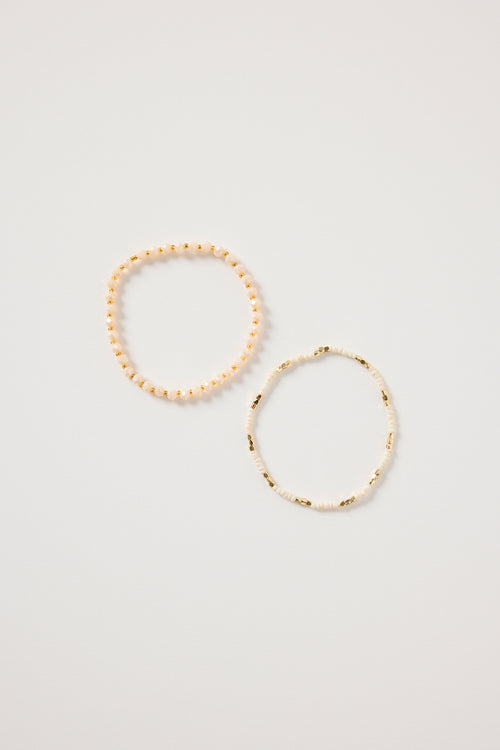 Cream and gold double beaded bracelet featuring mixed ivory beads and metallic gold accents, styled in a layered loop on a white background. Delicate women’s jewellery ideal for stacking, gifting and everyday wear.