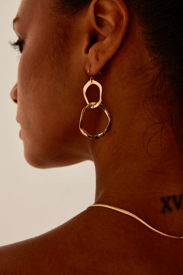 model wearing double link gold earrings