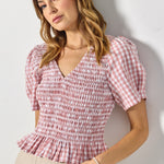 model wears pink gingham blouse