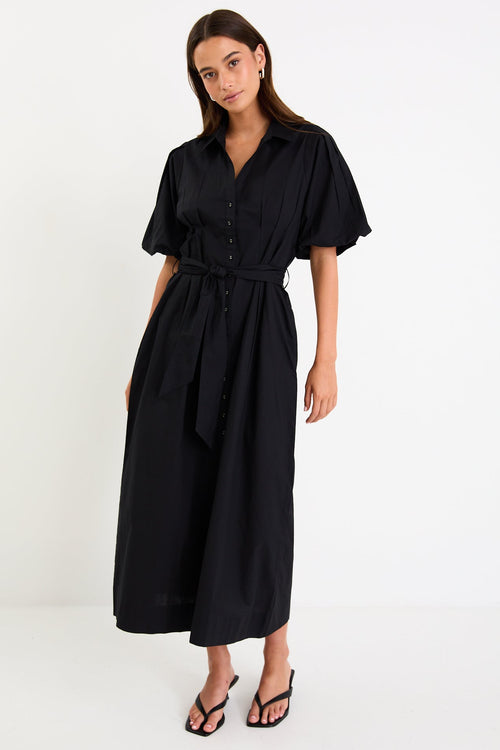 Woman wearing a black dress with a belt on a white background