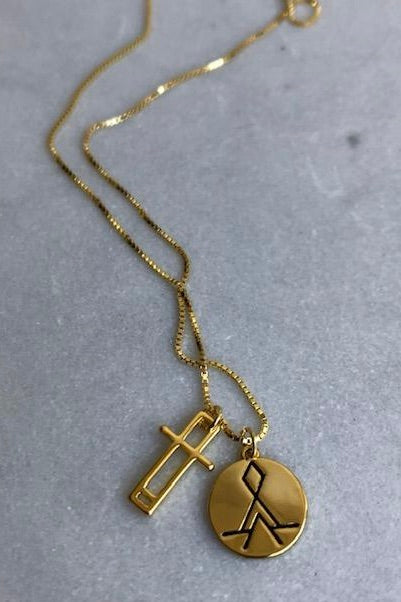 gold necklace with symbol and fine chain