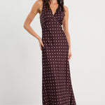 Woman wearing a patterned dress on a white background