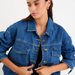 Model wearing a storm-blue denim jacket with patch pockets, button front and a relaxed fit.