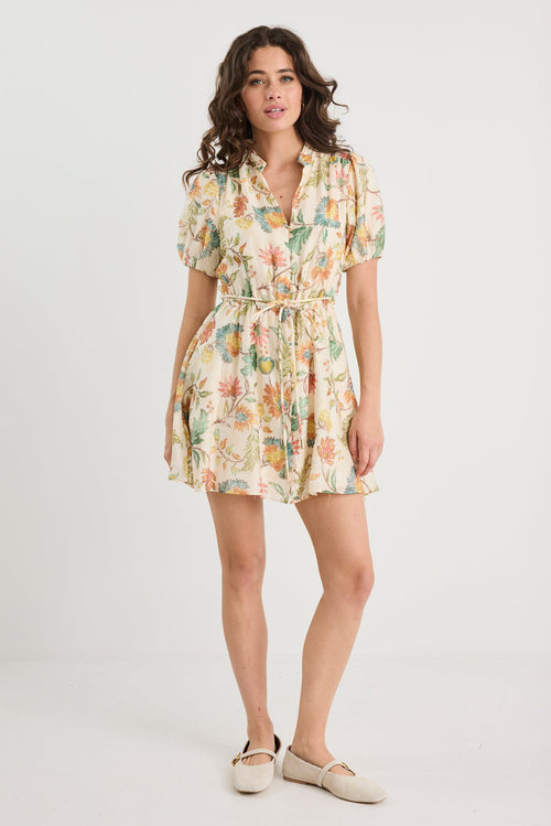 Woman wearing a floral dress on a white background