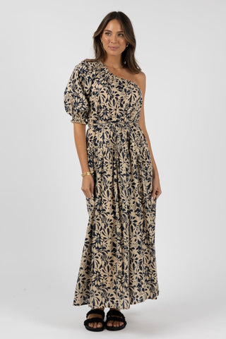 model wears a navy floral one shoulder maxi dress