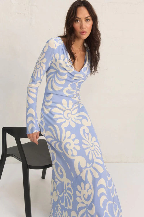 Model wears a blue long sleeve floral print maxi dress