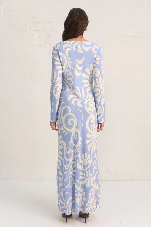 Model wears a blue long sleeve floral print maxi dress