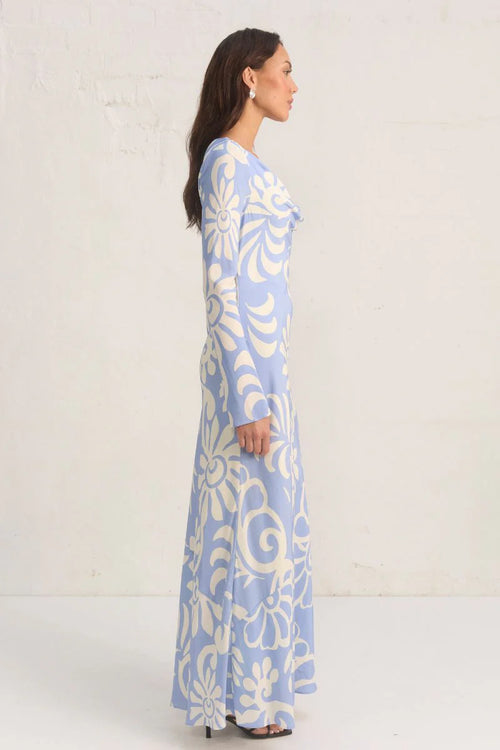 Model wears a blue long sleeve floral print maxi dress