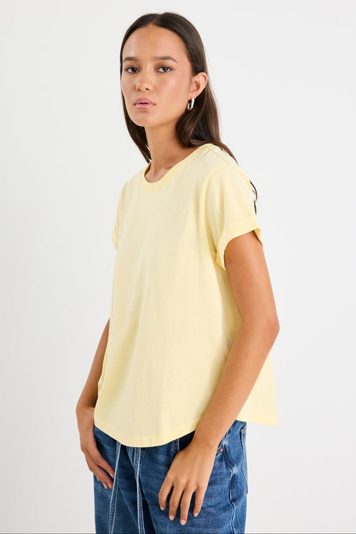 Woman wearing a yellow tee and blue jeans
