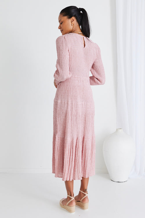 model wears a pink long sleeve dress