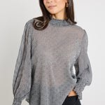 Model wears sheer black gingham long sleeve top