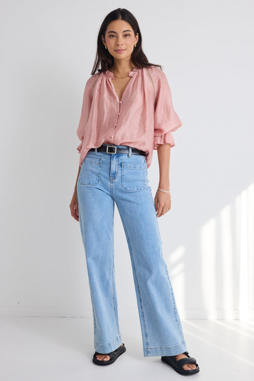 model wears a pink blouse