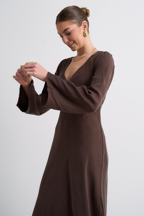 Model wears a brown maxi dress