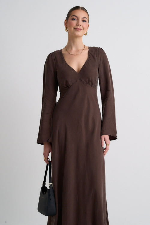 Model wears a brown maxi dress