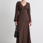 Model wears a brown maxi dress