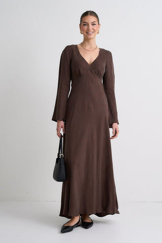 Model wears a brown maxi dress