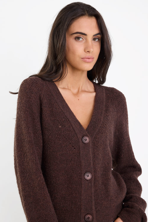 Woman wearing a brown cardigan on a white background