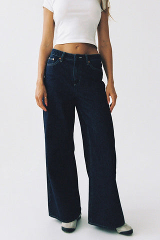 model wears blue wide leg jean