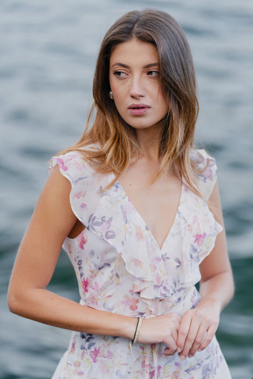 model wears a white floral maxi dress