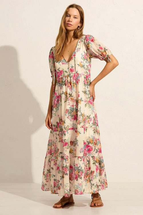 Model wears white floral maxi dress