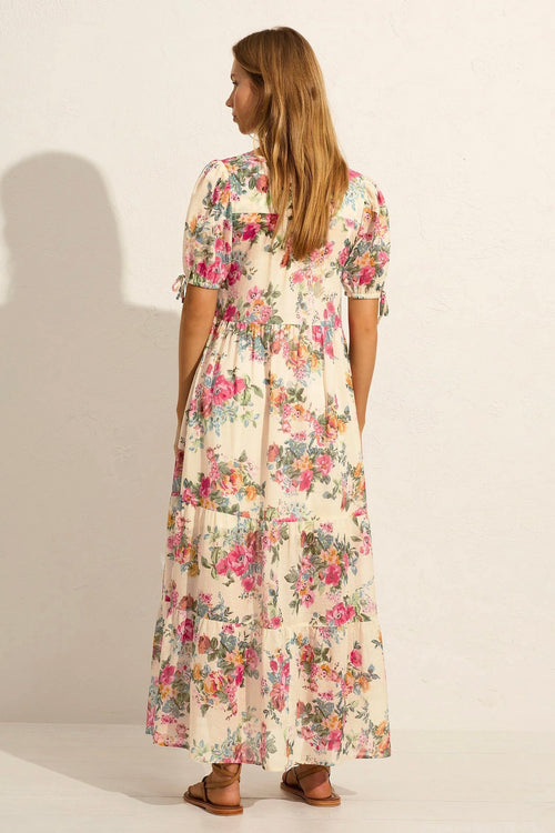 Model wears white floral maxi dress