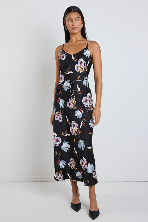 model wears black floral satin maxi dress