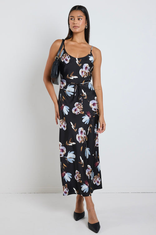 model wears black floral satin maxi dress