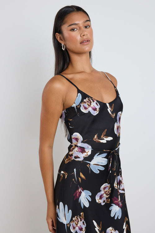 model wears black floral satin maxi dress