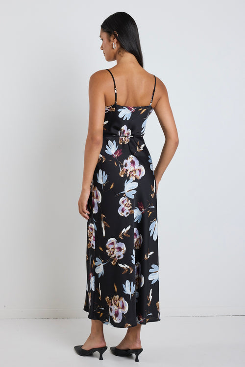 model wears black floral satin maxi dress