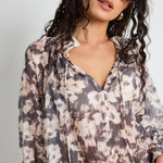 Model wears floral sheer top