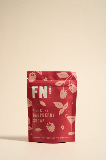 A pouch of FN brand Raspberry Sugar Rim Dust with a floral and fruit design, predominantly pink and red in color.
