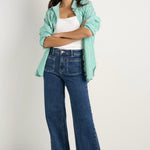 model wears a blue wide leg jean