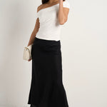 model wears a black linen midi skirt