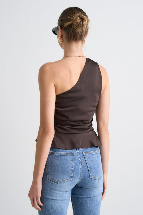 model wears a brown one shoulder top