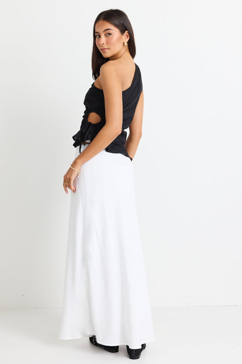 model wears a white linen maxi skirt