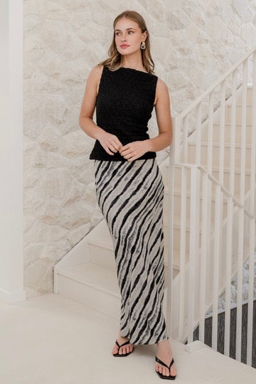 Woman wearing Charcoal Irregular Stripe Satin Bias Midi Skirt and black top