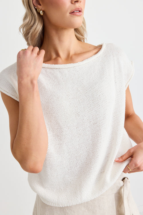 model wears a white off the shoulder top