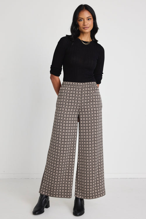 model wears black print pants