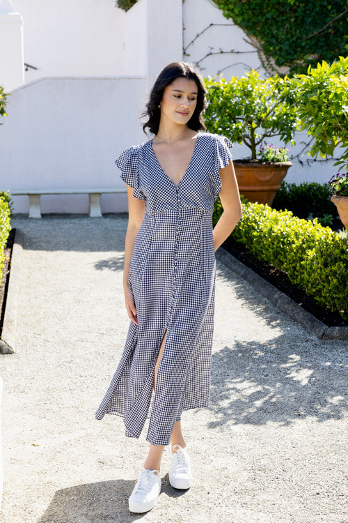 model wears a navy gingham midi dress