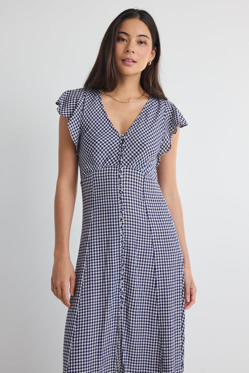 model wears a navy gingham midi dress