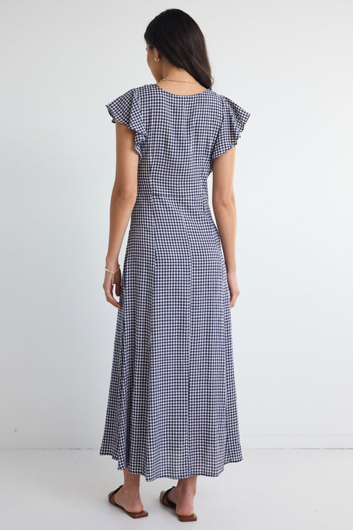 model wears a navy gingham midi dress