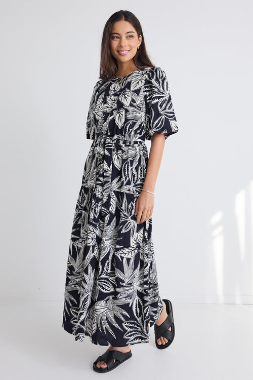 model wears a black white floral print maxi dress