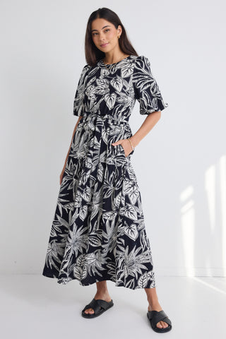 model wears a black white floral print maxi dress